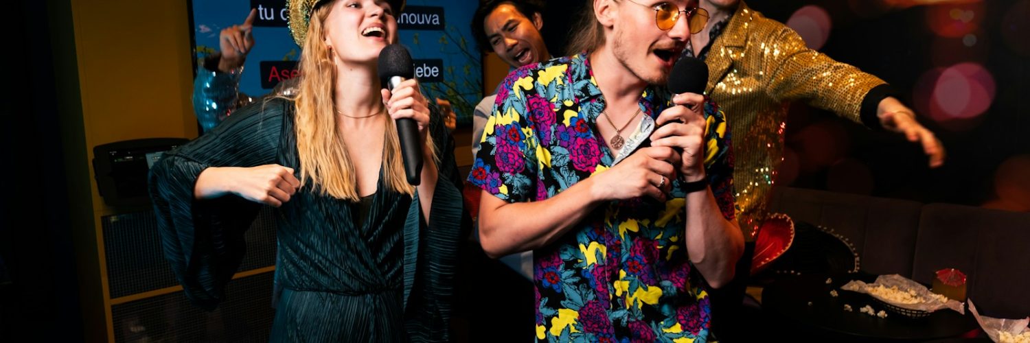 A group of people standing around each other in a room